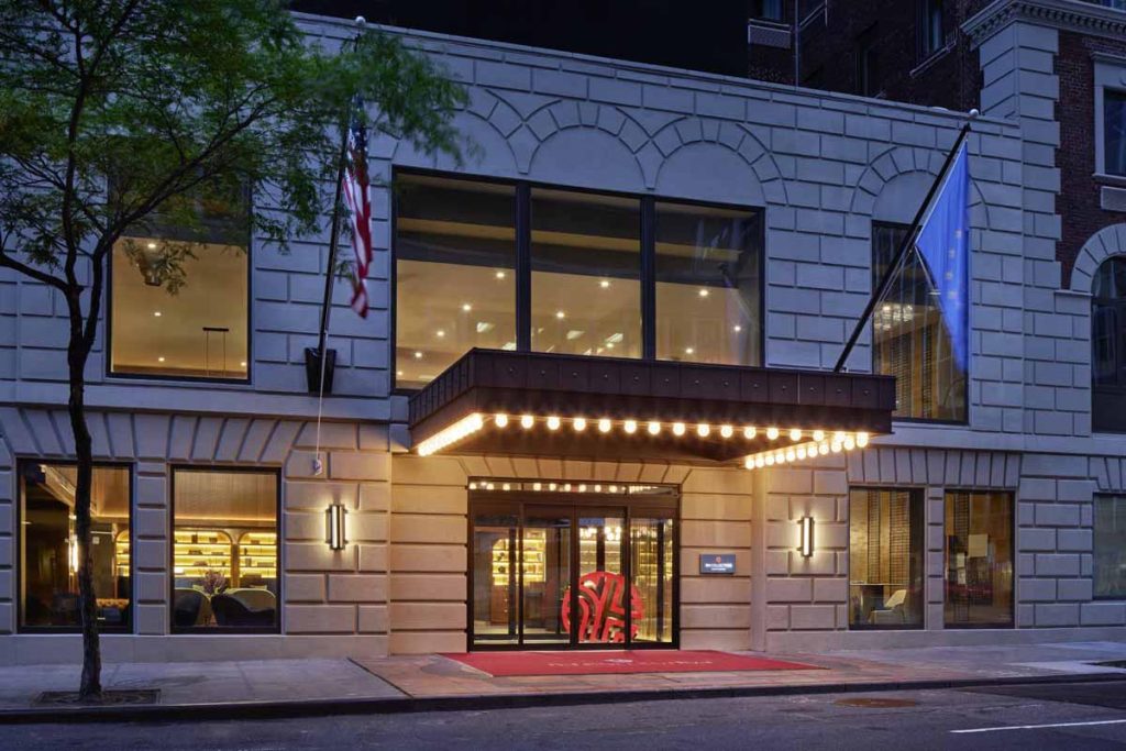 Exterior of a stately hotel lit up at night