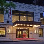 Exterior of a stately hotel lit up at night
